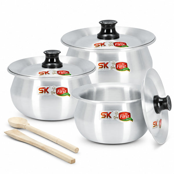 Three-piece stainless steel cookware set with black handles and lids, including two pots and one deep pan, shown with two wooden spoons on a white background. The pots feature SK First logo stickers.
