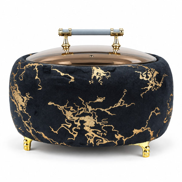 A round velvet storage box or basket in black with a gold marble pattern, featuring a glass lid, gold feet, and a light blue handle on a white background.