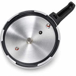 A stainless steel pressure cooker lid with a black handle and black rubber gasket, shown from an overhead angle on a white background.