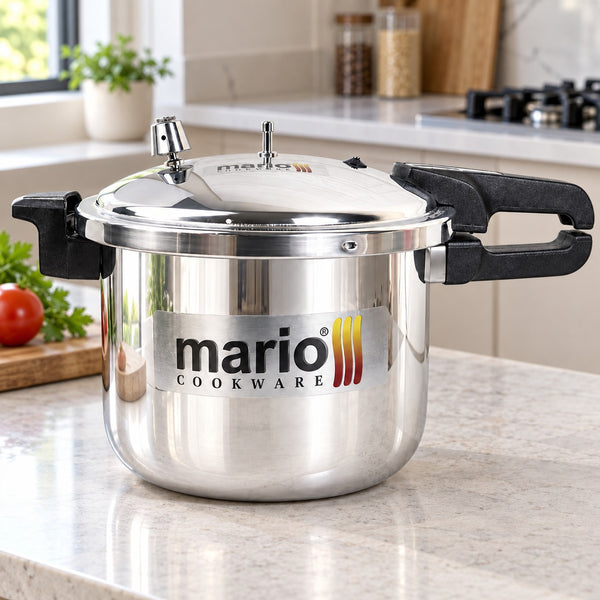 A stainless steel pressure cooker with black handles and a silver lid, featuring a Mario Cookware logo decal on the front, set on a kitchen countertop.