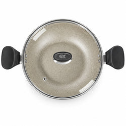 Top-down view of a speckled beige non-stick pot with a clear glass lid and black handles, featuring a central SK logo.