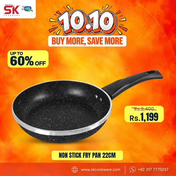 A promotional graphic for a non-stick frying pan. The pan is black with a speckled interior and a black handle, shown against a bright orange and yellow background with sale text, a SK cookware logo, and a price of Rs.