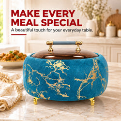 A round decorative storage box or container with a blue velvet exterior, gold marble pattern, and gold feet, shown on a marble tabletop in a styled kitchen setting. Large text at the top reads, 'MAKE EVERY MEAL SPECIAL A beautiful touch for your everyday table.