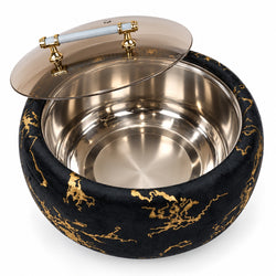 Round black velvet stool or ottoman with gold metallic pattern detailing, featuring a clear glass lid with a gold-toned handle, shown open to reveal a stainless steel interior.