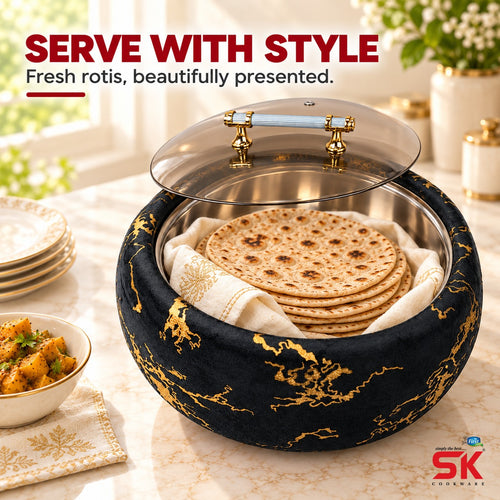A round black fabric-covered serving basket with gold marbled detailing, a clear glass lid, and brass handles, shown on a marble table with flatbread inside. Red text at the top reads 'SERVE WITH STYLE' and a small SK Cookware logo appears in the bottom right corner.